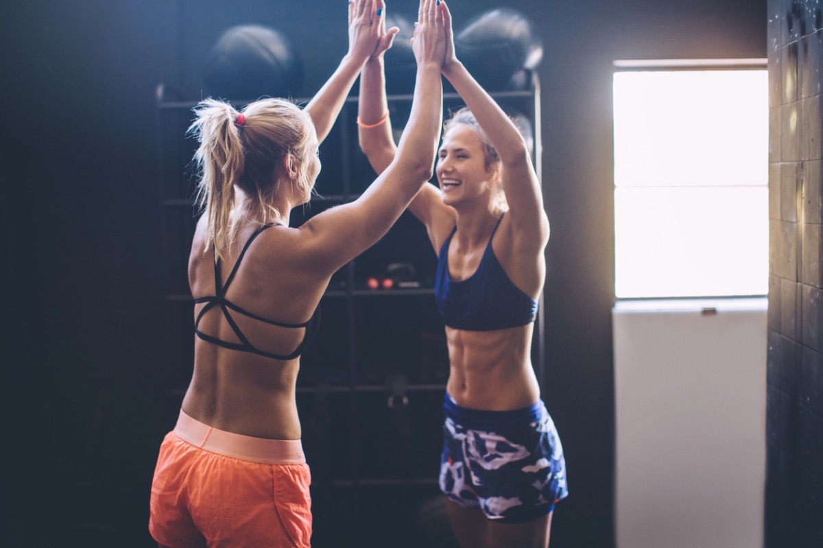 Two friends challenging each other to work out